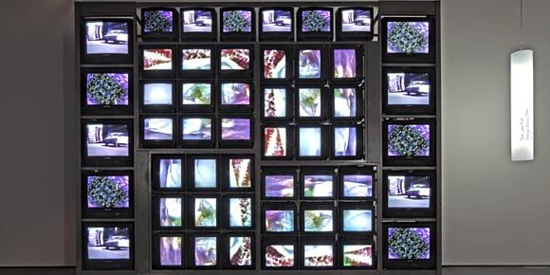 stack of different-sized monitors showing images of a car and a microchip