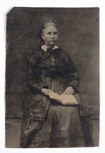 Unknown photographer. Unknown Woman Reading an Embossed Book, tintype photograph (c. 1860s). 